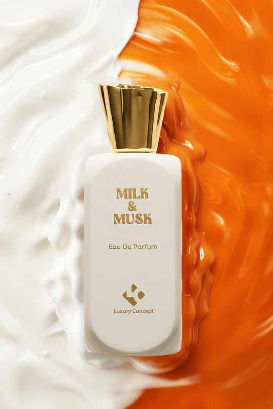 A rectangular white perfume bottle with a shiny gold cap, labeled 'MILK & MUSK Eau De Parfum', is a gourmand lactonic musk perfume set against a split background of white cream and vibrant orange liquid swirls.