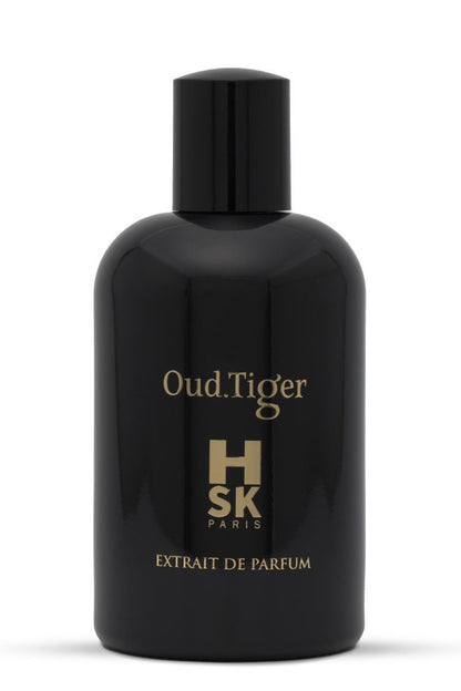 A glossy black bottle of HSK Oud.Tiger Extrait de Parfum with gold lettering, set against a plain white background.