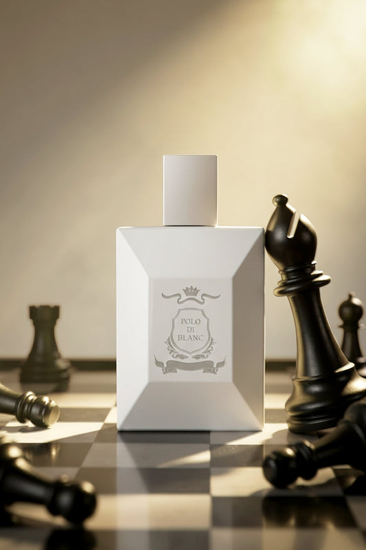 Fresh Ozonic Floral perfume ideal for Summer. A white rectangular perfume bottle with a matching white cap stands centered on a chessboard, surrounded by black and silver chess pieces under dramatic warm lighting. The bottle label reads 'INTO DE BLANC'.